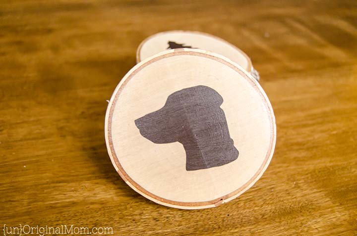 DIY Painted Wood Slice Coasters - cut a vinyl stencil or buy a pre-made one from the craft store for these easy and personal handmade gifts. (They make great gifts for guys!)