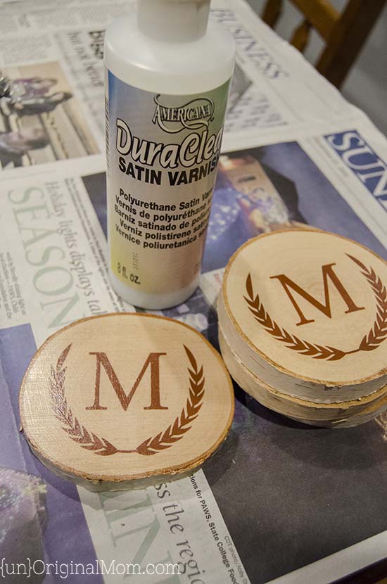 DIY Painted Wood Slice Coasters - cut a vinyl stencil or buy a pre-made one from the craft store for these easy and personal handmade gifts. (They make great gifts for guys!)