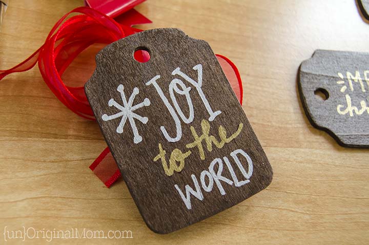 Rustic stained wood gift tags with metallic sharpie paint pens. A beautiful addition to holiday wrapping!