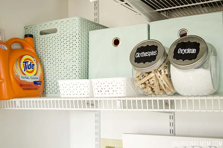 Organizing ideas and solutions for a small, multi-purpose laundry closet, complete with bins, labels, drawers, and even a pretty laundry sign!