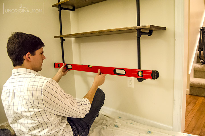 Really detailed step-by-step tutorial to make your own industrial pipe shelving - this is an affordable and fun way to get the Joanna Gaines Fixer Upper style in your own home! | fixer upper shelves | industrial pipe shelves | DIY pipe shelving tutorial | pipe shelves | industrial farmhouse office