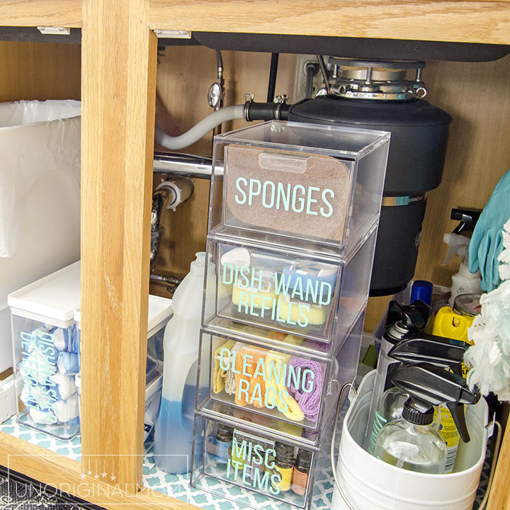 How to organize under the kitchen sink - great ideas from this realistic before and after! Love those acrylic drawers and vinyl labels! #underthesink #organization #kitchenorganization #organizationideas #undersinkorganization