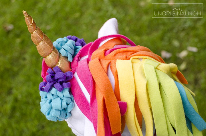 DIY Unicorn Hoodie Costume + Rainbow Tutu. Adorable unicorn costume made out of a hoodie! Love the rainbow tutu. Perfect for little girls. Make it no-sew by using hot glue instead! #unicorn #unicorncostume #easydiycostume