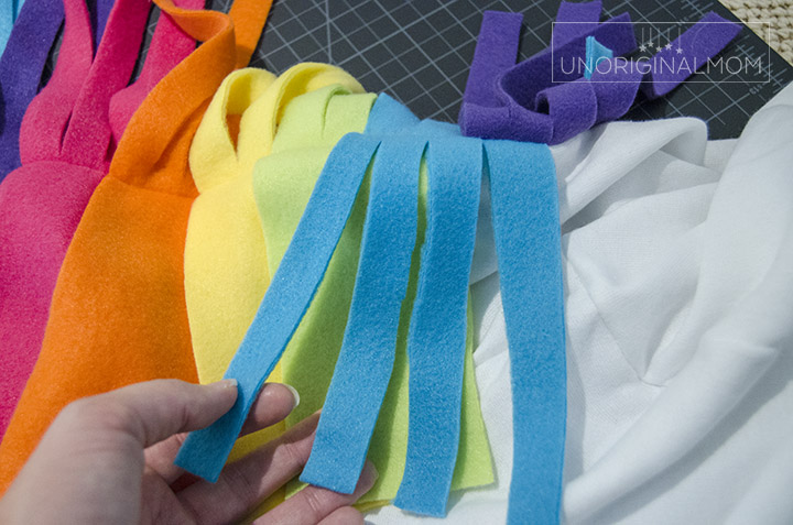 Use fleece strips to make a unicorn mane and tail on a DIY unicorn hoodie costume.