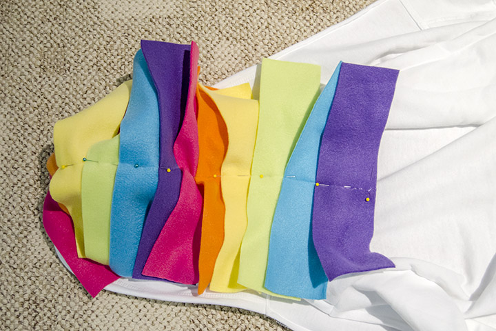 Use fleece strips to make a unicorn mane and tail on a DIY unicorn hoodie costume.