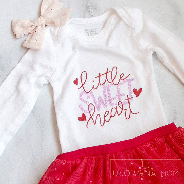 Little Sweet Heart Valentine's Onesie with a free cut file for Silhouette and Cricut! Adorable Valentine's Day onesie for a little girl with glitter heat transfer vinyl.