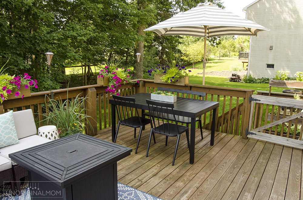 Modern black patio table with a butterfly leaf - great use of space on this small deck.