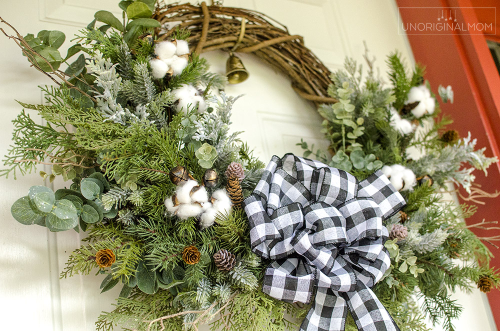 DIY Farmhouse Christmas Wreath - use a mix of evergreen faux florals with eucalyptus, cotton, and twigs to make a beautiful natural farmhouse christmas wreath!