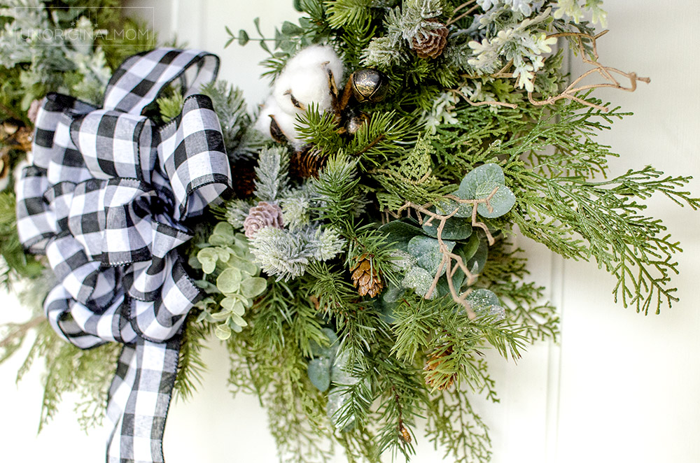 DIY Farmhouse Christmas Wreath - use a mix of evergreen faux florals with eucalyptus, cotton, and twigs to make a beautiful natural farmhouse christmas wreath!