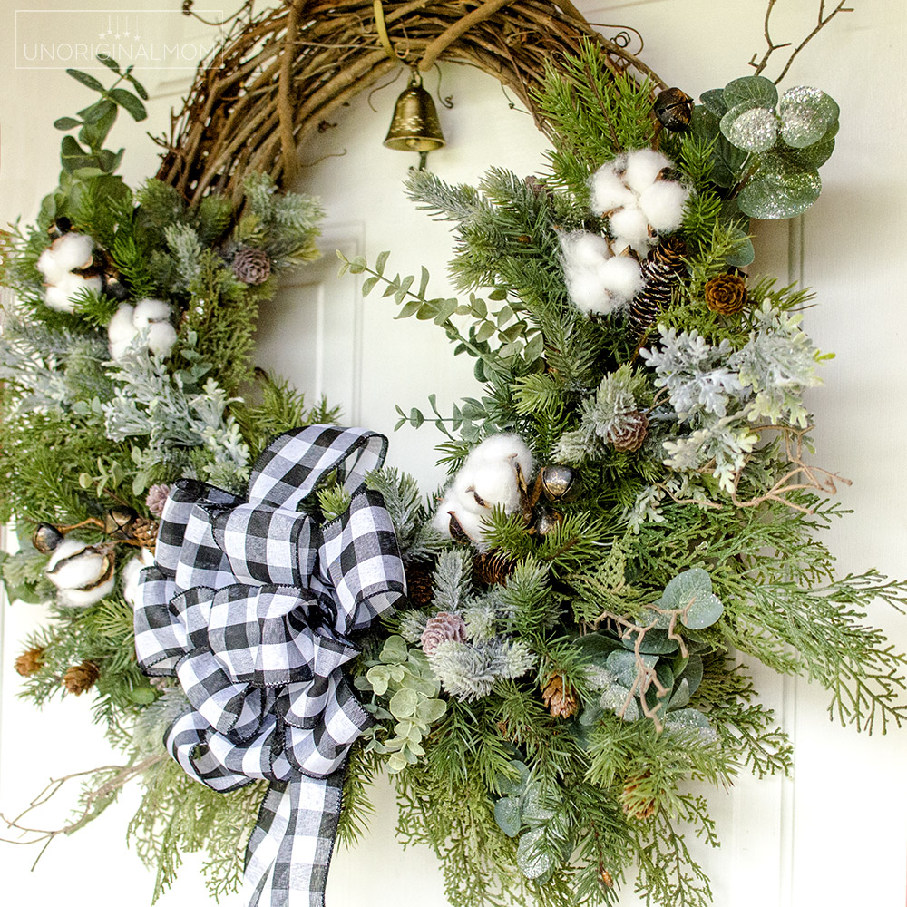 DIY Farmhouse Christmas Wreath - use a mix of evergreen faux florals with eucalyptus, cotton, and twigs to make a beautiful natural farmhouse christmas wreath!