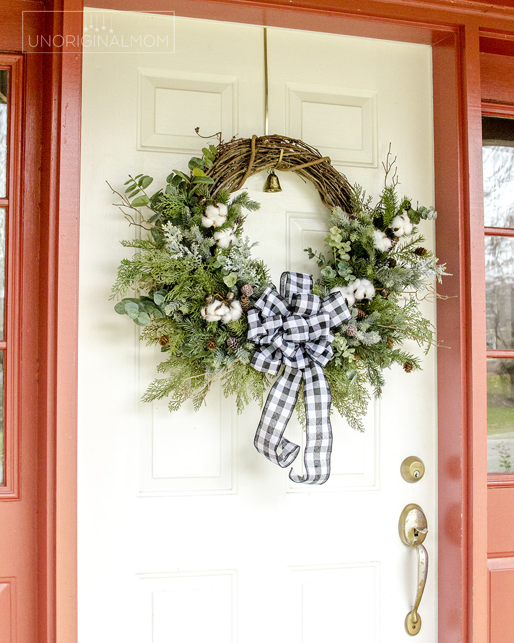 DIY Farmhouse Christmas Wreath - use a mix of evergreen faux florals with eucalyptus, cotton, and twigs to make a beautiful natural farmhouse christmas wreath!