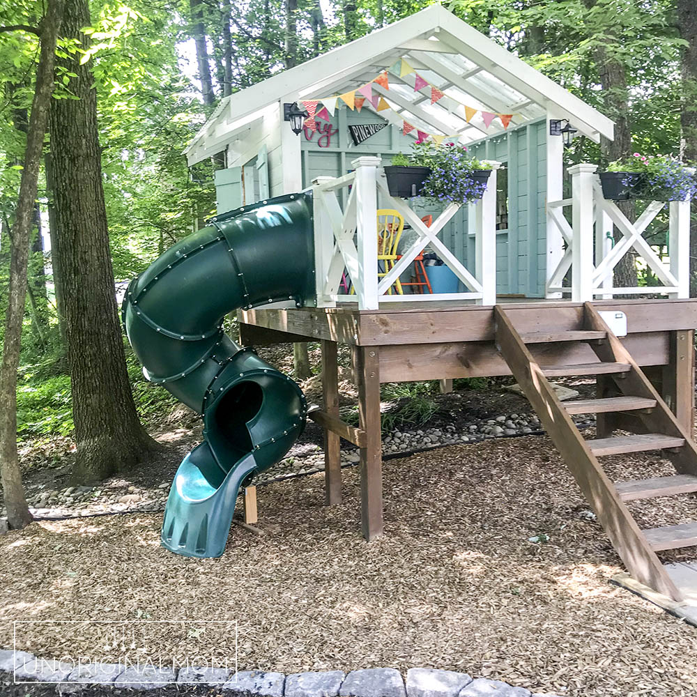 DIY backyard playhouse with curly tube slide