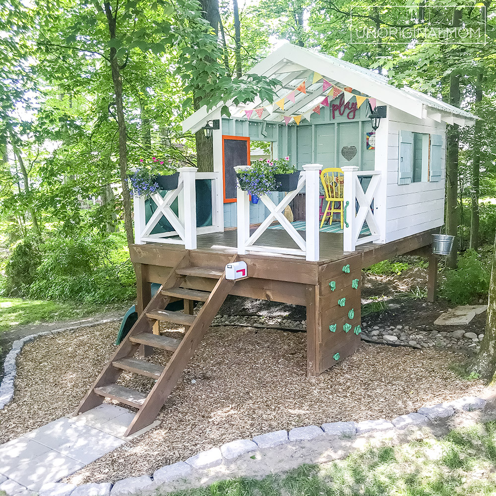 DIY Backyard Playhouse with Slide - this version of the Handmade Hideaway is a perfect raised playhouse for a sloped or wooded backyard! Playhouse landscaping ideas.