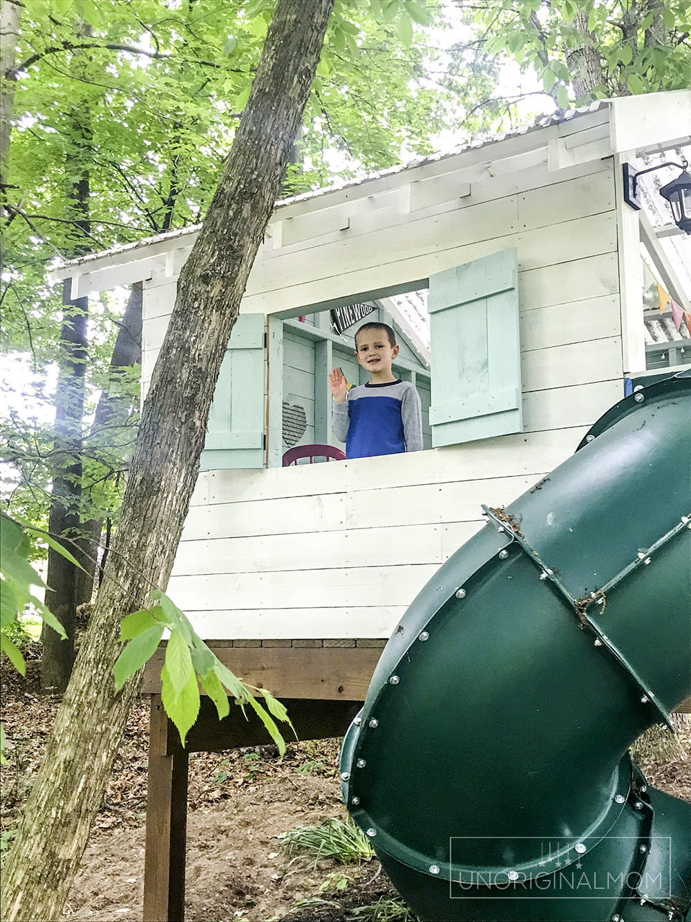 DIY Backyard Playhouse with Slide - this version of the Handmade Hideaway is a perfect raised playhouse for a sloped or wooded backyard!