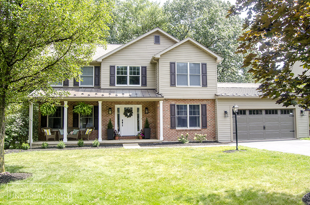 90s colonial exterior renovation with standing seam steel roof