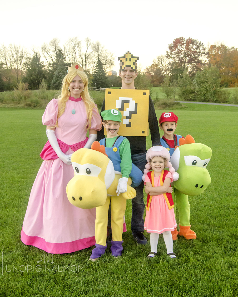 DIY Family Mario Halloween Costumes - Mario riding yoshi, toadette, princess peach, and a question mark block!